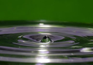 Concentric ripples of water on a green background