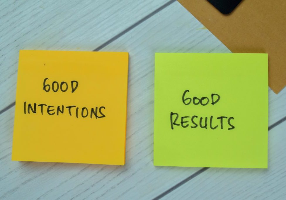 Concept of Good Intentions and Good Results write on sticky notes isolated on Wooden Table.