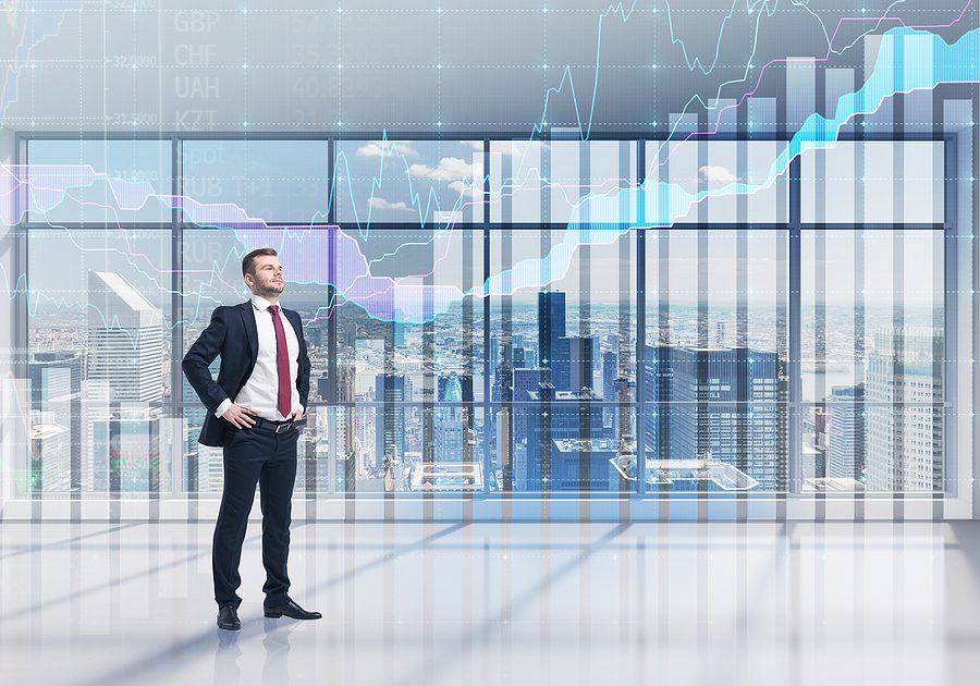 Full-length confident person in formal suit. A modern panoramic office with New York city view and forex chart. A concept of the asset management.